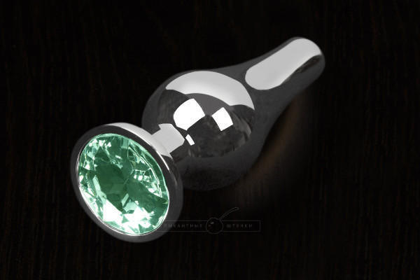 Анальная пробка маленькая Пикантные Штучки с зеленым кристаллом, серебристая, 8.5 см